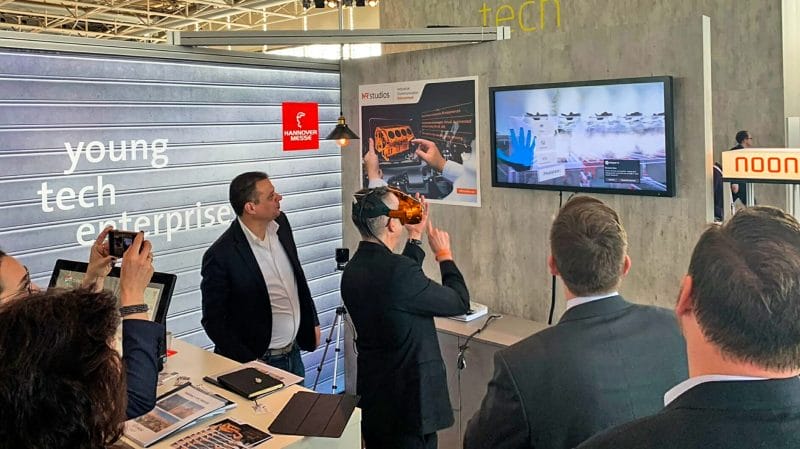 Men standing on an expo stall using VR goggles