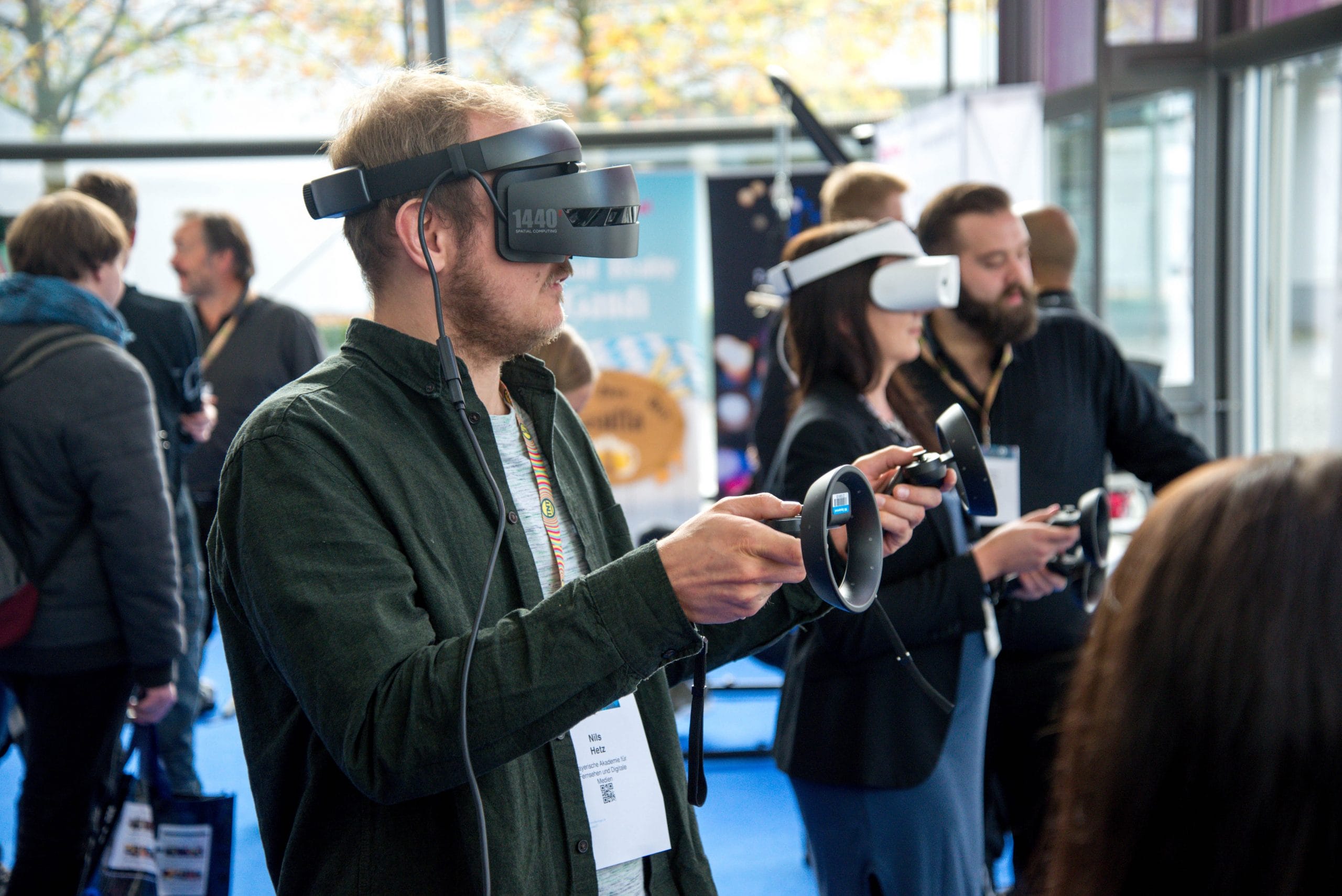 Man using VR headset while using controllers to interact with the application