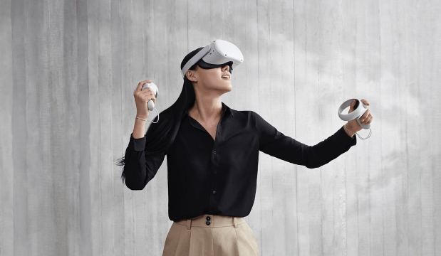 Stock image of woman using VR headset and joysticks